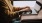 woman types on her laptop near large window