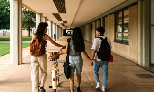 a group of people walking down a sidewalk
