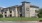 a large building with a lawn in front of it