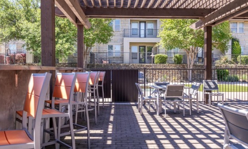 a patio with tables and chairs