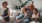 mother sits on a couch with her daughters while her son plays a video game