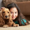 a person lying on the floor with a dog