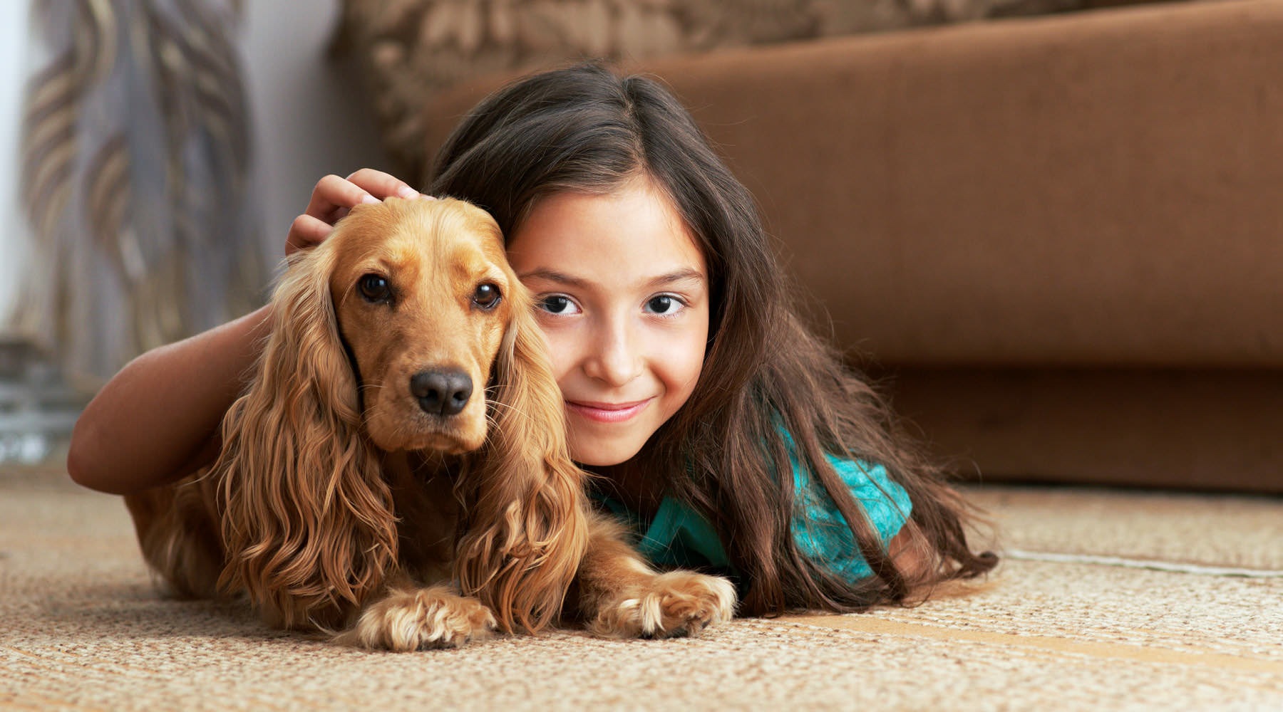 We're a pet-friendly community a person lying on the floor with a dog