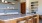 a kitchen with a bar and chairs