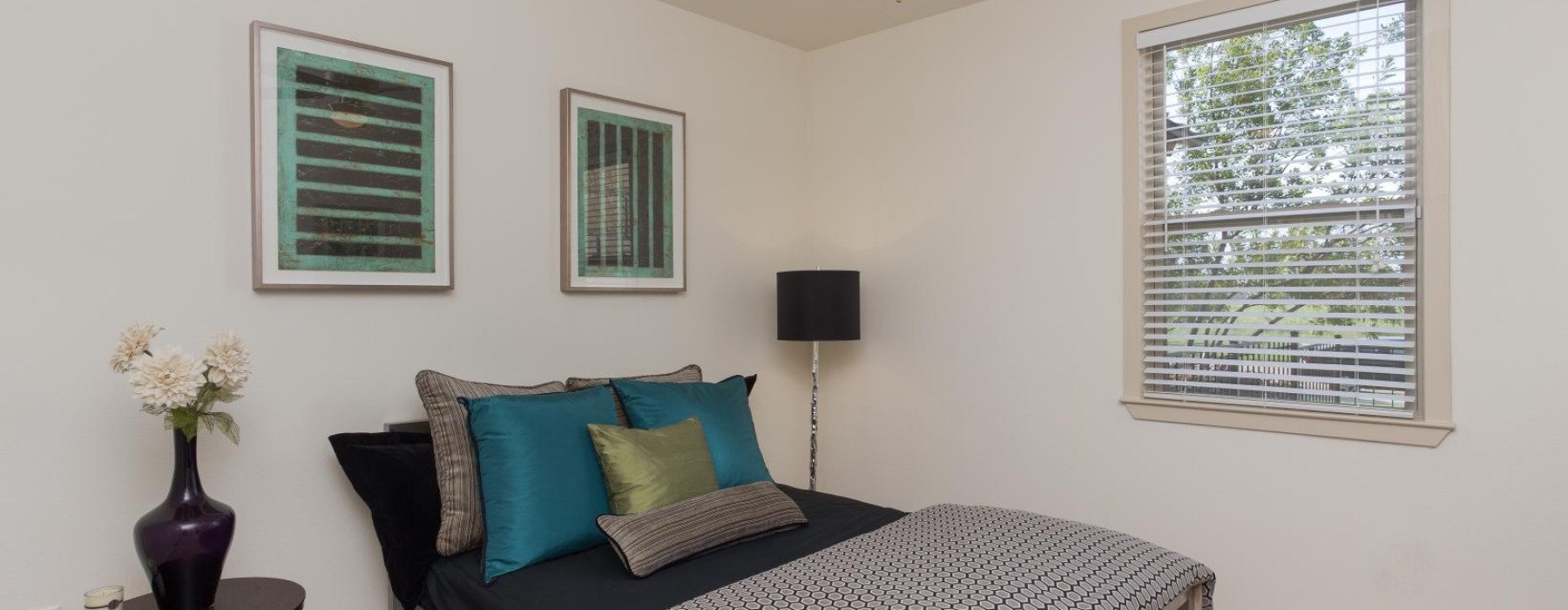 a bedroom with a bed and a fan